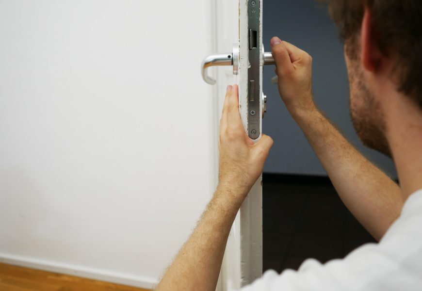 person holds door lever