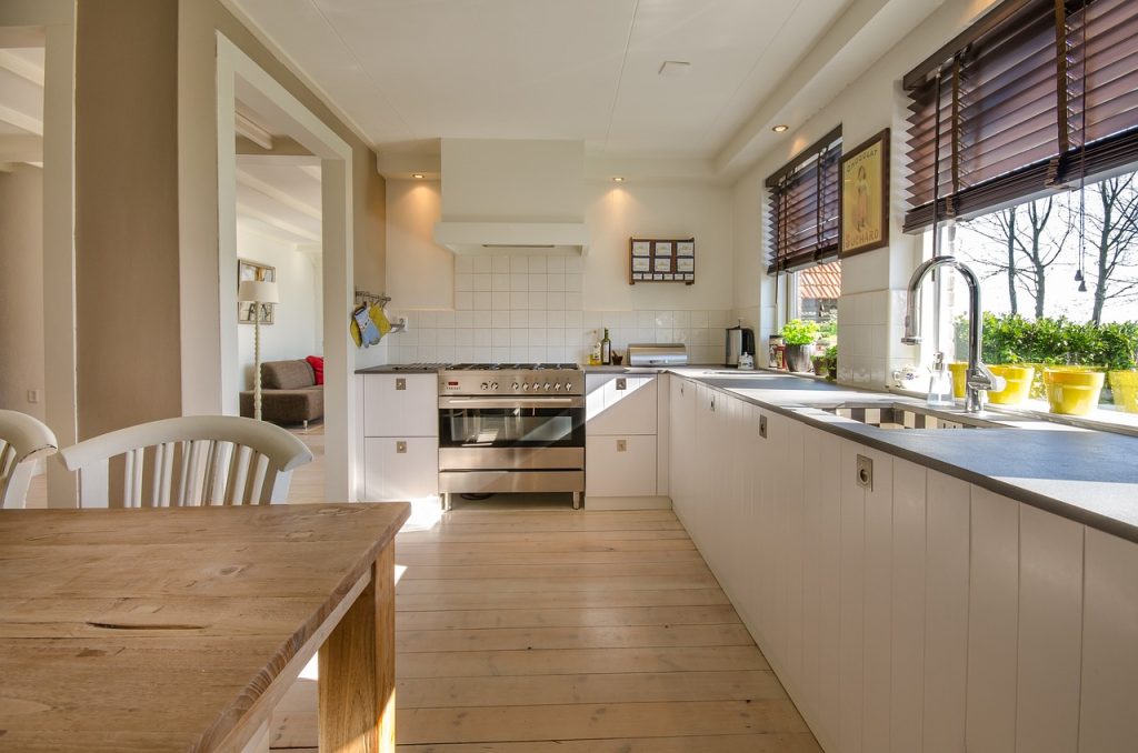 A well-lit kitchen showcasing a table with chairs, perfect for family meals and gatherings